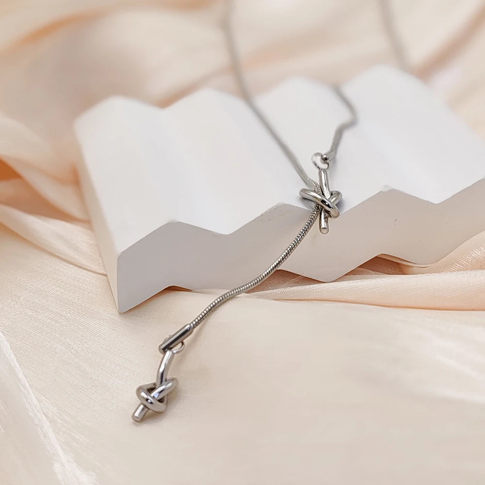 eManco “Inner Dialogue Pendant” — Two Knots, One Chain: For the Woman Who Talks to Herself Before She Talks to the World