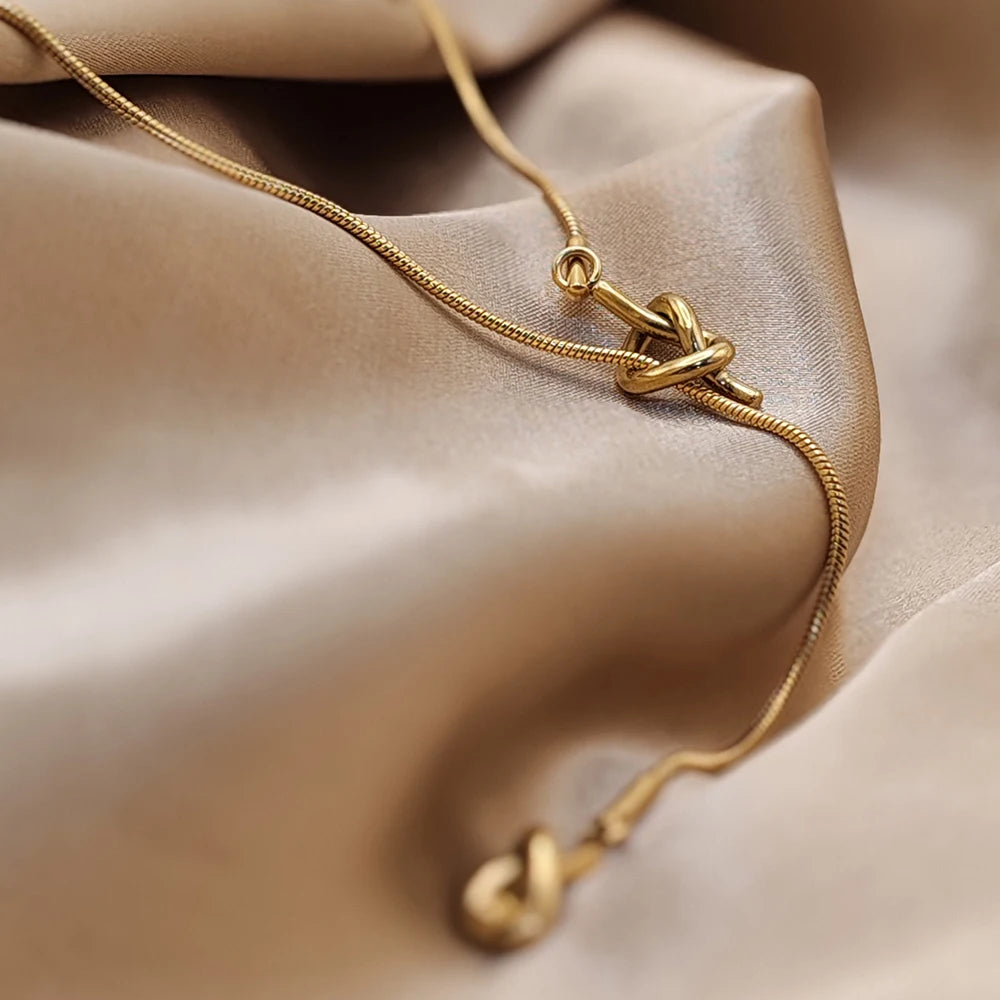 eManco “Inner Dialogue Pendant” — Two Knots, One Chain: For the Woman Who Talks to Herself Before She Talks to the World