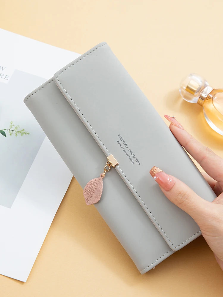 Hot Selling spring and summer new women's PU leather Japanese and South Korea small fresh leaf pendant three fold bag large capa