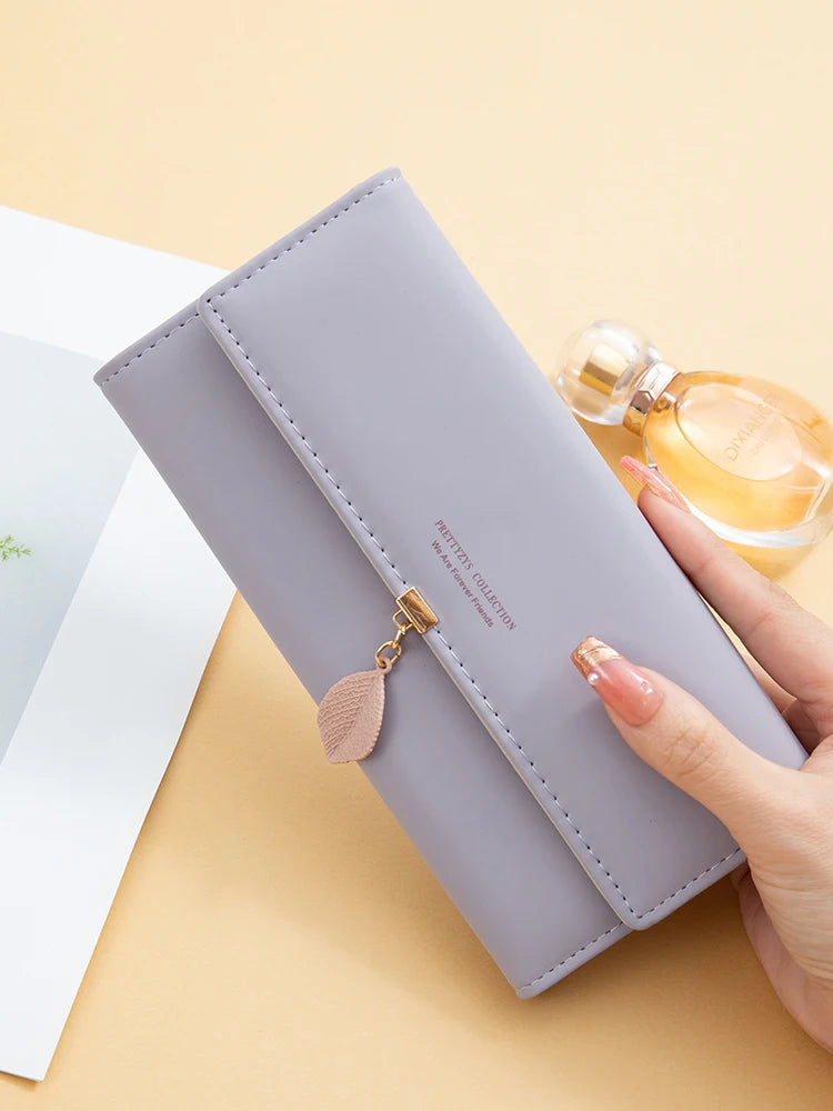 Hot Selling spring and summer new women's PU leather Japanese and South Korea small fresh leaf pendant three fold bag large capa